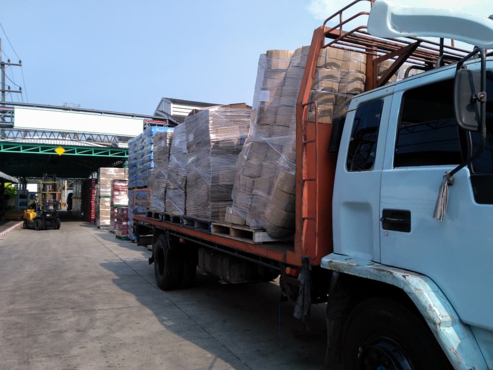 Damaged goods on trucks due to transport accident; mishap during sorting and placement of goods.