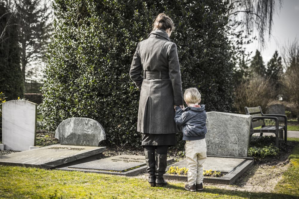 Woman with child at graveyard