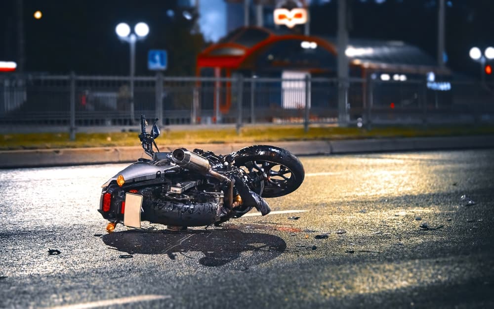 motorcycle lying on asphalt after a road accident