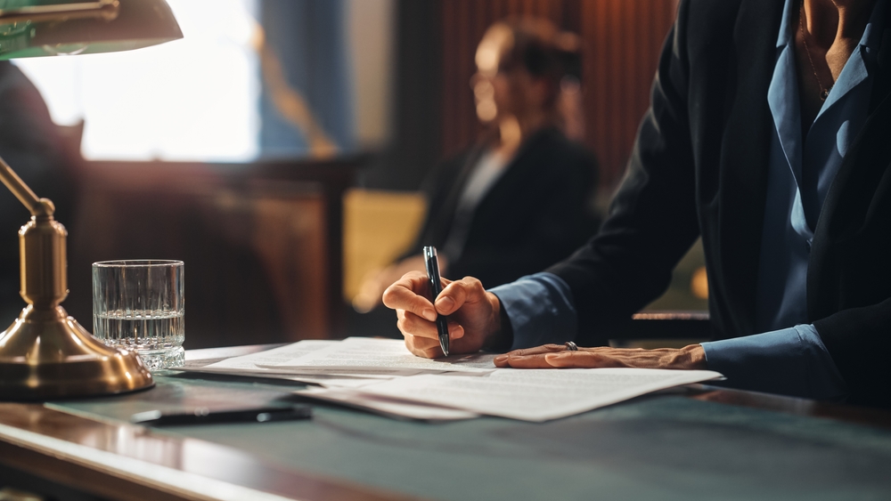 Court of Justice and Law Trial: Female Public Defender Writes Down Arguments for Defence Strategy.